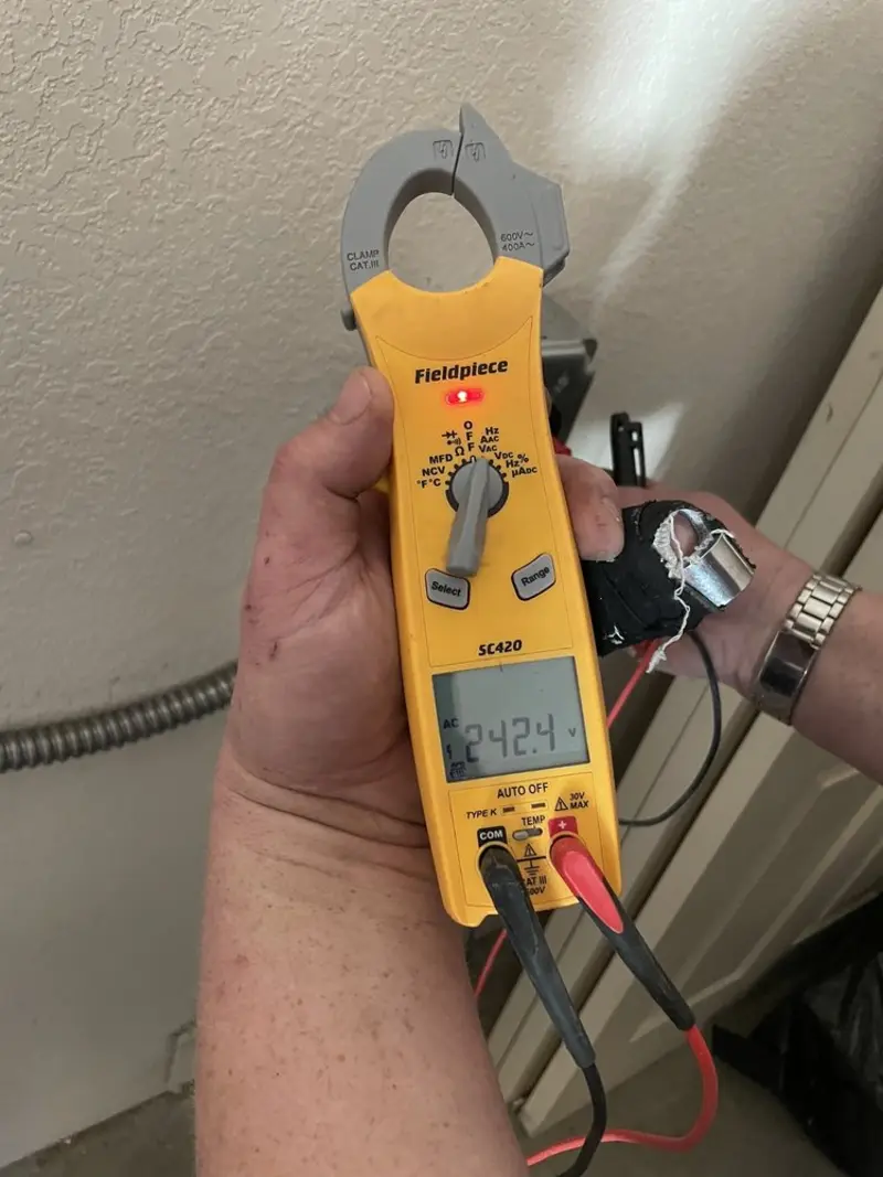 Voltage testing with clamp meter during Recessed Lighting Installation in Severance